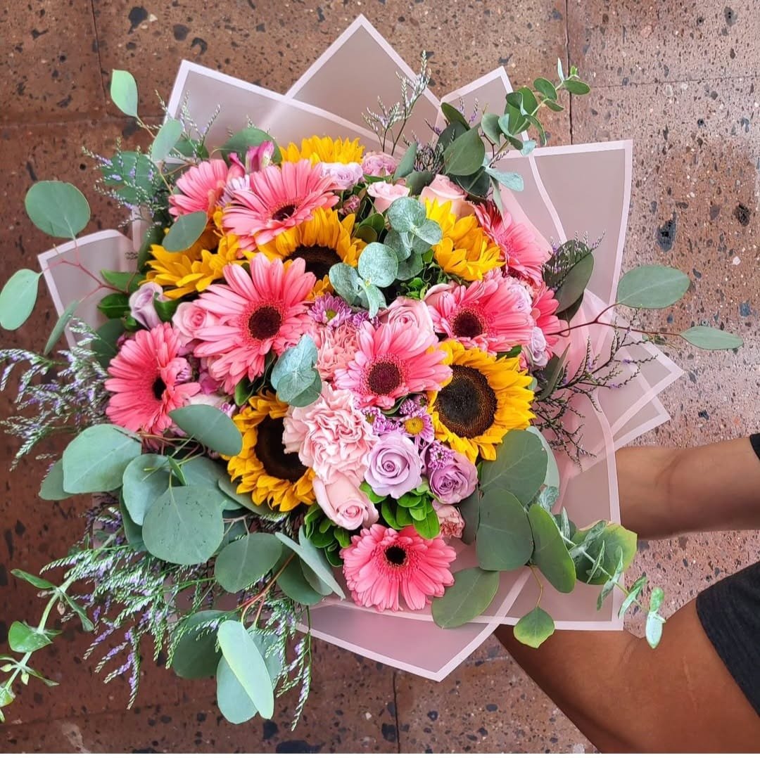 Ramo mixto con girasoles grandes, rosas rojas, gerberas coloridas y claveles frescos para envío sin costo en Ciudad Juárez.